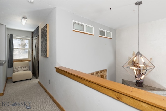 hallway featuring light colored carpet