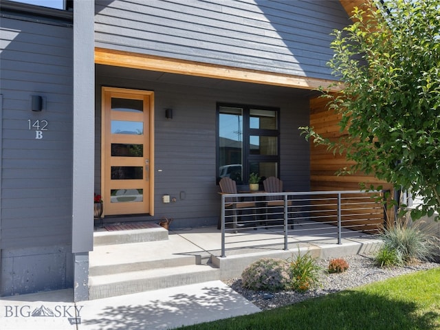 view of exterior entry featuring a porch