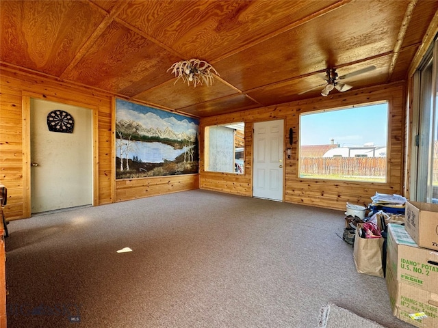 interior space with wood walls, wood ceiling, and carpet floors