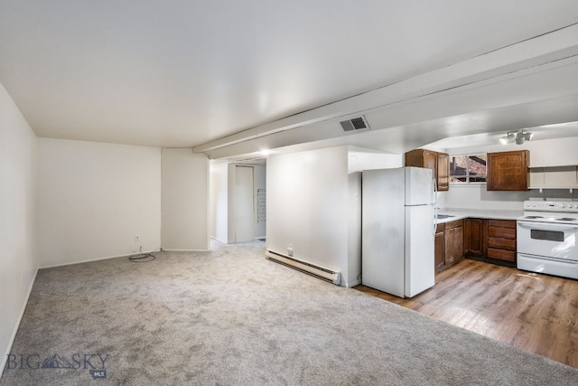 kitchen with light wood-type flooring, a baseboard heating unit, and white appliances