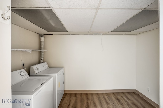 laundry area with hardwood / wood-style flooring and washer and clothes dryer