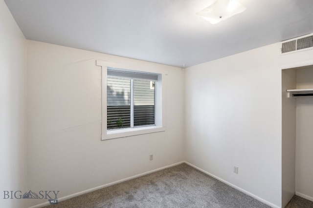 unfurnished bedroom featuring carpet flooring and a closet