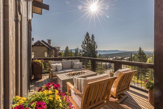 56 Outlook Trl, Big Sky, MT 59716 - deck with an outdoor living space with a fire pit and a mountain view