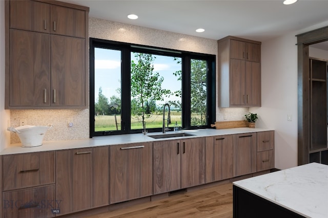 kitchen with sink and light hardwood / wood-style flooring