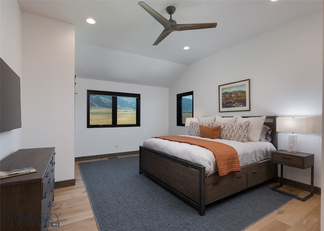 bedroom featuring ceiling fan, vaulted ceiling, and light wood-type flooring