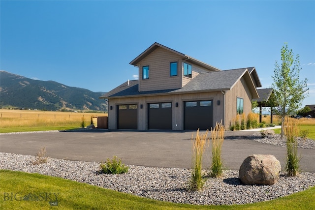 view of property exterior with a garage and a mountain view