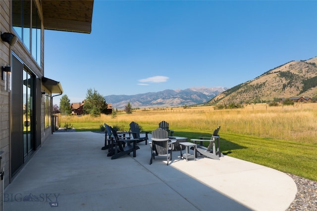 view of patio / terrace with a mountain view and a rural view