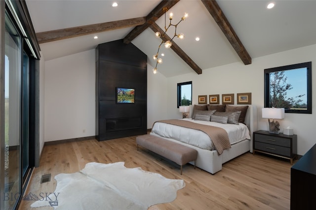 bedroom featuring beam ceiling, high vaulted ceiling, a large fireplace, and light hardwood / wood-style floors