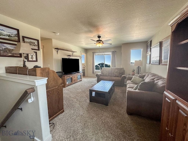 carpeted living area featuring a textured ceiling and a ceiling fan