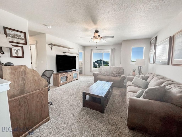 living room featuring a textured ceiling, ceiling fan, and carpet floors