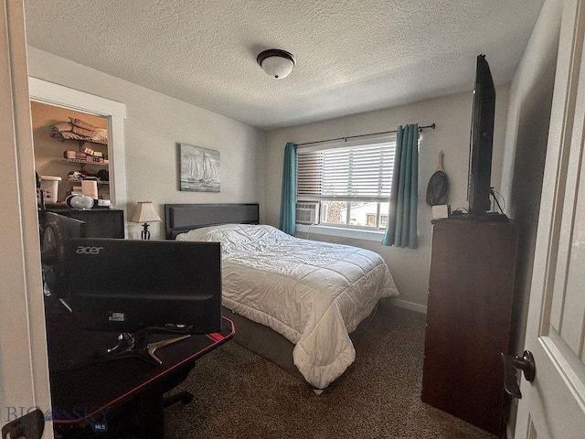 carpeted bedroom featuring baseboards and a textured ceiling