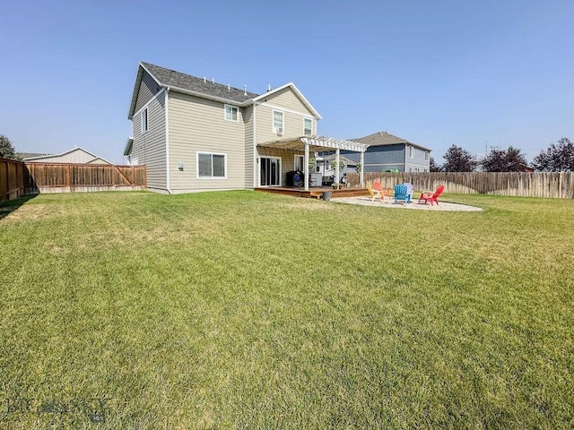 rear view of property with a patio area, a lawn, a fenced backyard, and a pergola