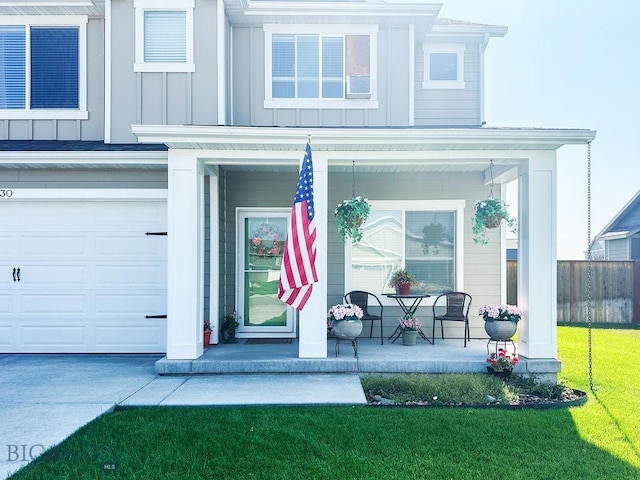 view of exterior entry featuring a porch, a lawn, and board and batten siding