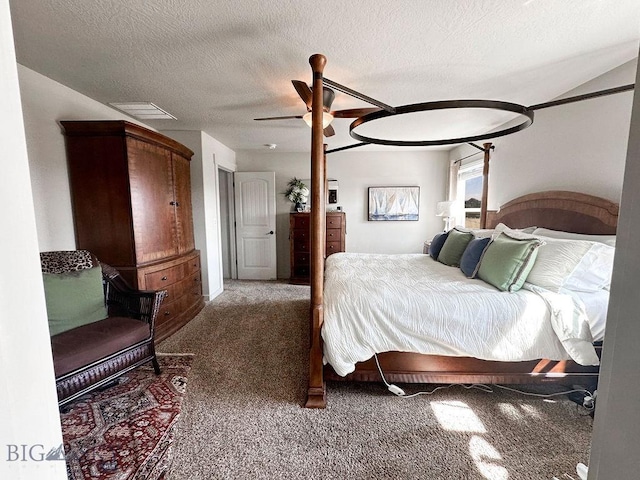 bedroom with visible vents, a textured ceiling, carpet, and a ceiling fan