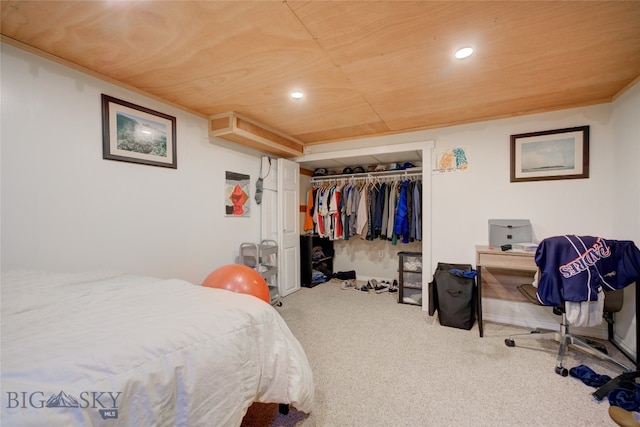 bedroom featuring a closet, carpet flooring, and wooden ceiling