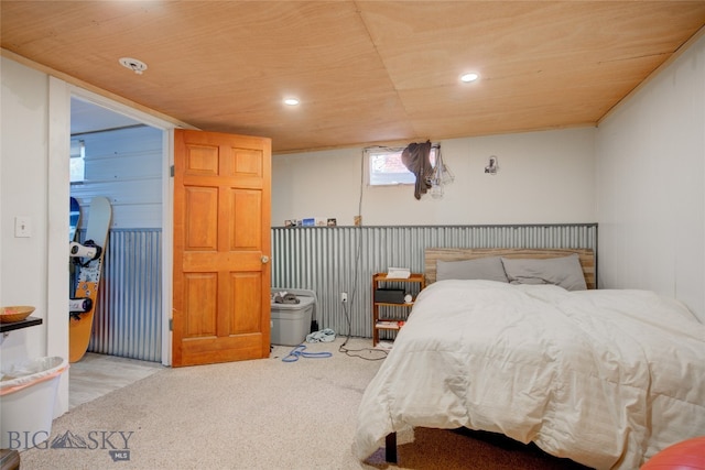 carpeted bedroom with wood walls and wooden ceiling