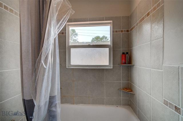 bathroom with shower / bath combo with shower curtain