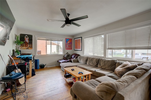 living room featuring ceiling fan, hardwood / wood-style flooring, and a healthy amount of sunlight