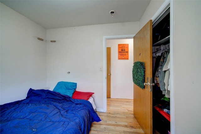 bedroom with a closet and wood-type flooring