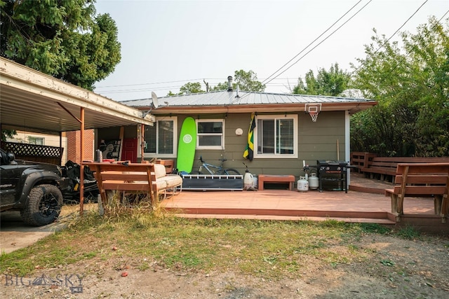 back of house featuring a wooden deck