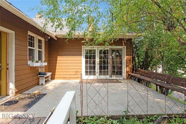 view of patio / terrace featuring a wooden deck and french doors