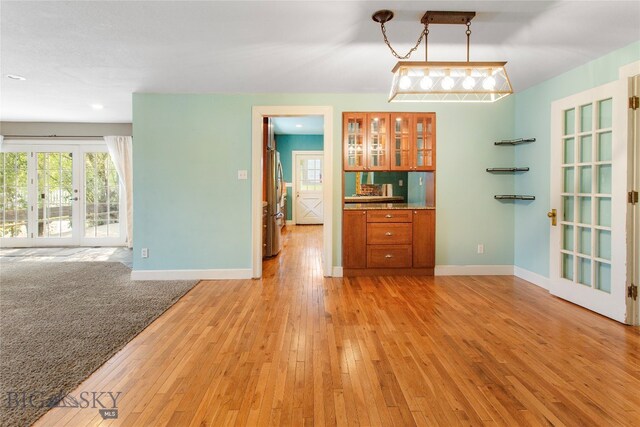 unfurnished dining area featuring light wood-type flooring