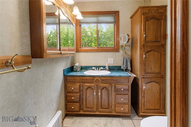 bathroom with vanity, toilet, and tile patterned flooring