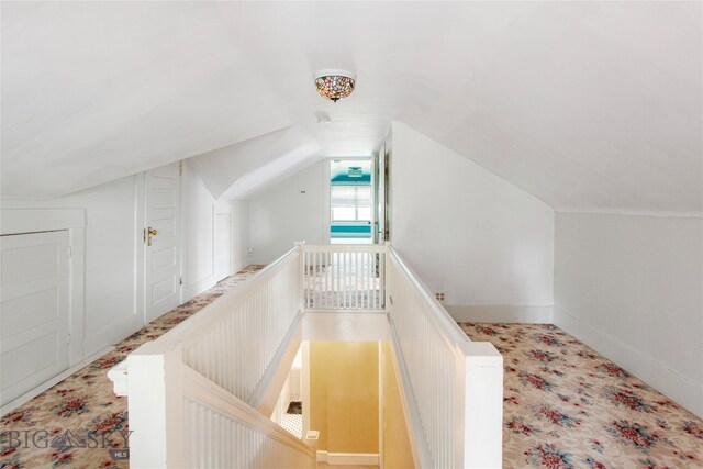 hallway with lofted ceiling