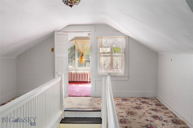 bonus room with lofted ceiling, carpet, and radiator heating unit