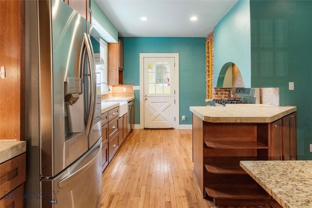 kitchen featuring light hardwood / wood-style flooring, stainless steel appliances, and sink