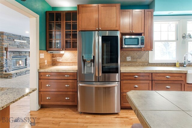 kitchen featuring light hardwood / wood-style flooring, backsplash, and stainless steel appliances