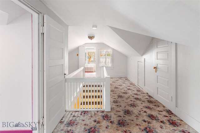 additional living space featuring vaulted ceiling and light carpet