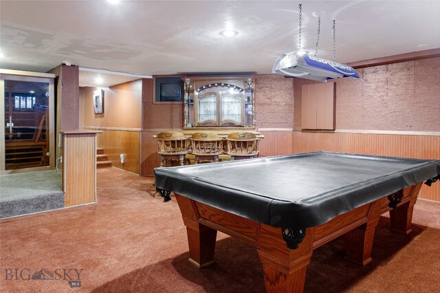 rec room with bar, pool table, and carpet floors