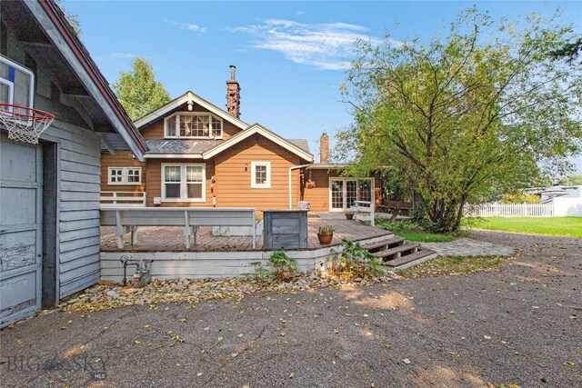 rear view of house with a wooden deck