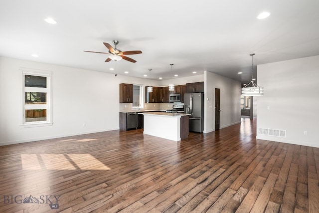 unfurnished living room with ceiling fan, dark hardwood / wood-style floors, and sink