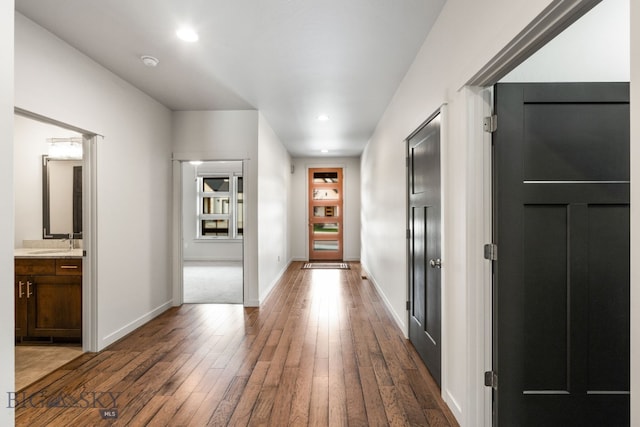 hallway with dark hardwood / wood-style floors and sink