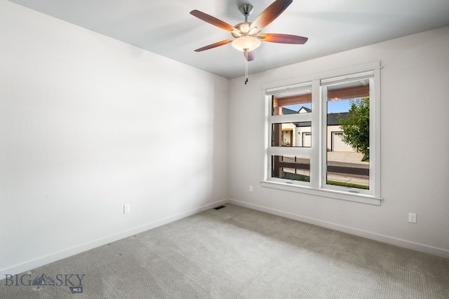 spare room with plenty of natural light, ceiling fan, and carpet floors