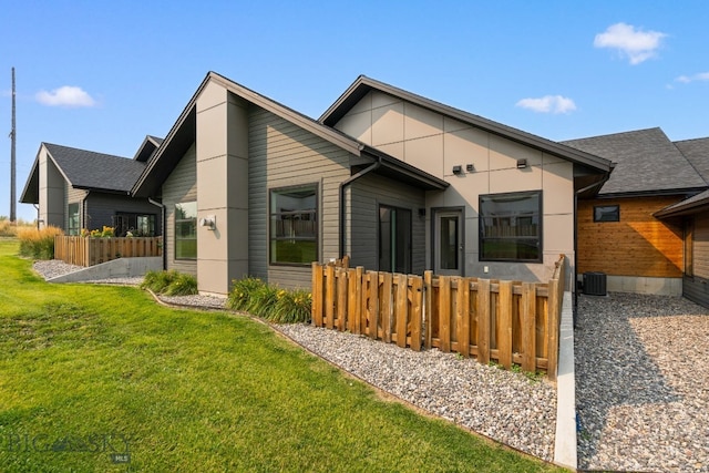 back of property featuring a yard and cooling unit