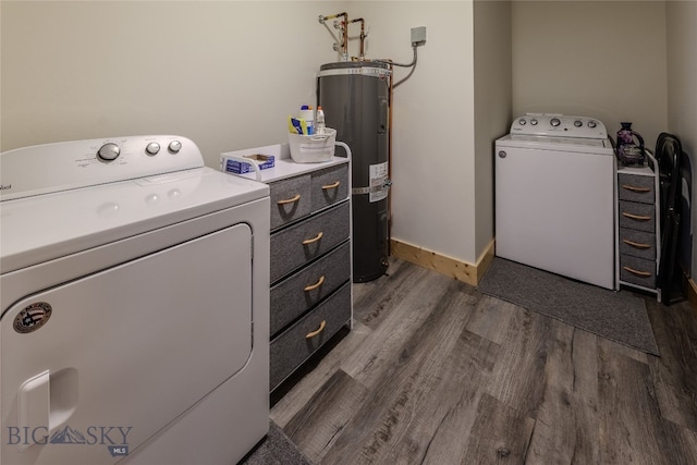 washroom featuring cabinets, washer and clothes dryer, hardwood / wood-style flooring, and water heater