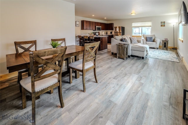 dining space featuring light wood-type flooring