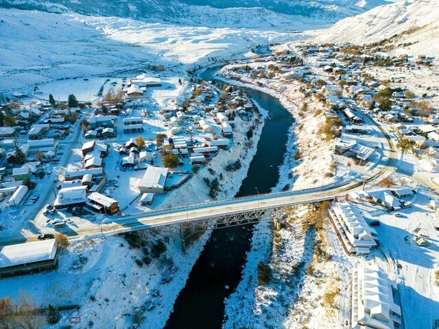 snowy aerial view featuring a mountain view