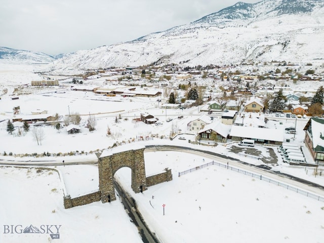 snowy aerial view with a mountain view