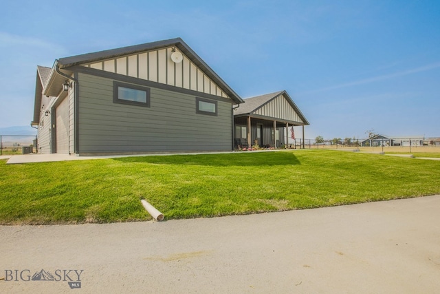 rear view of property with a yard