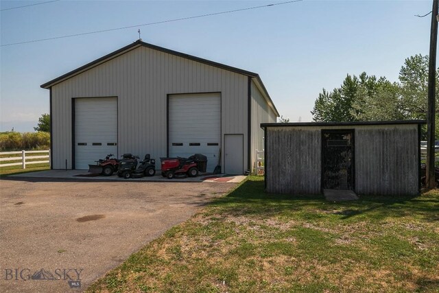 garage featuring a lawn