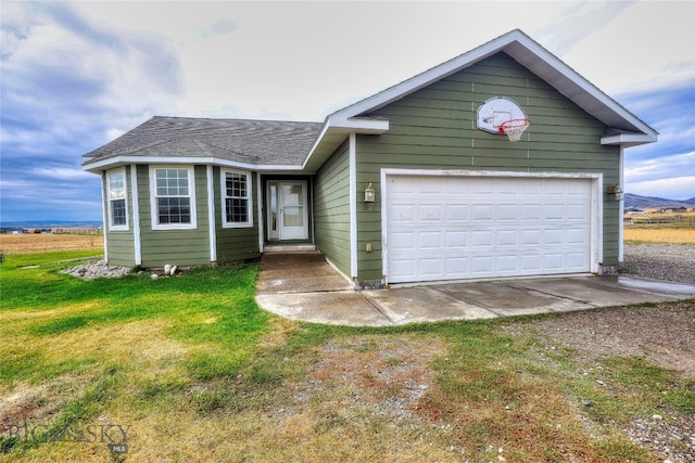 view of front of house with a garage, a rural view, and a front yard