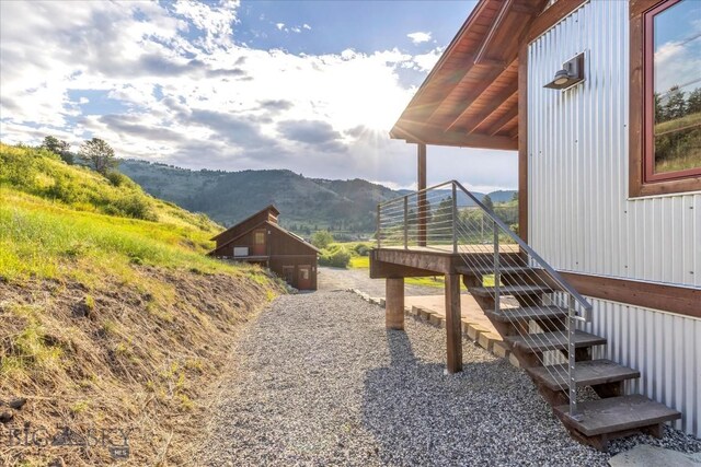 view of yard featuring a deck with mountain view