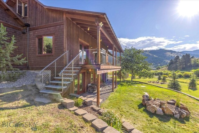 exterior space with a mountain view and a lawn