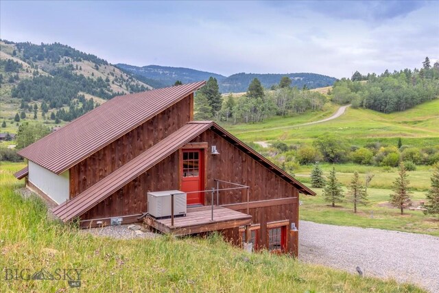 exterior space with a mountain view, a rural view, and an outdoor structure