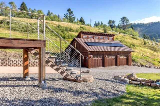 view of front of property featuring an outbuilding, a mountain view, and a rural view