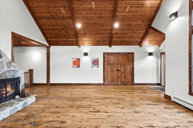 unfurnished living room with wooden ceiling, a baseboard heating unit, vaulted ceiling with beams, a fireplace, and wood-type flooring